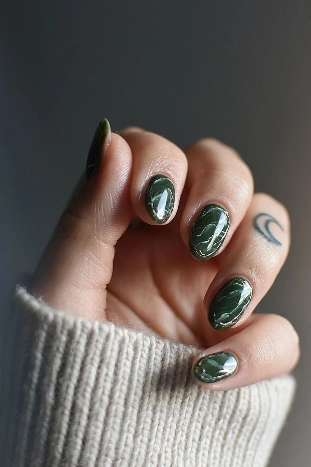 Dark green marble nails with chrome rings