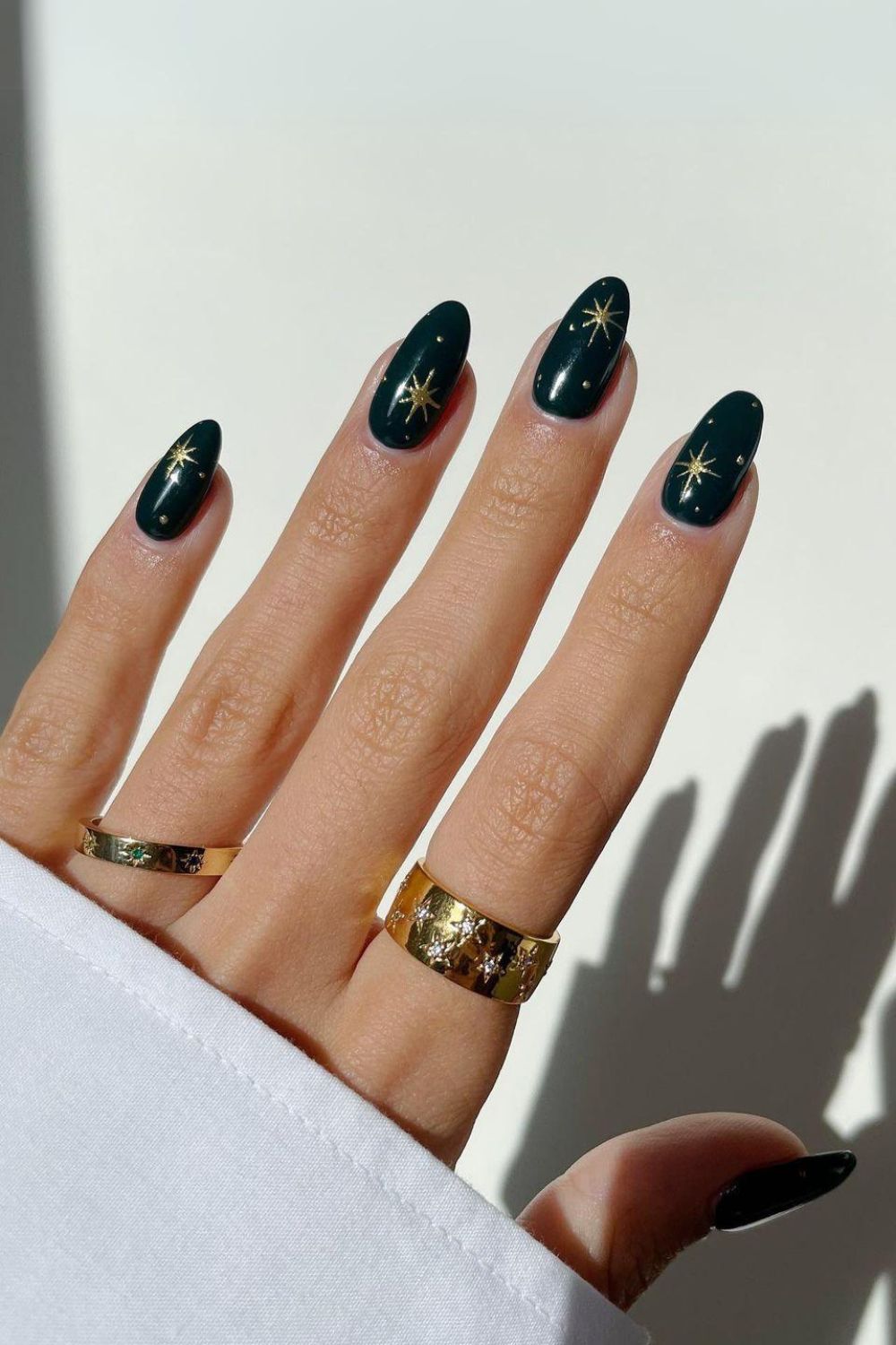 Dark green nails with chrome stars