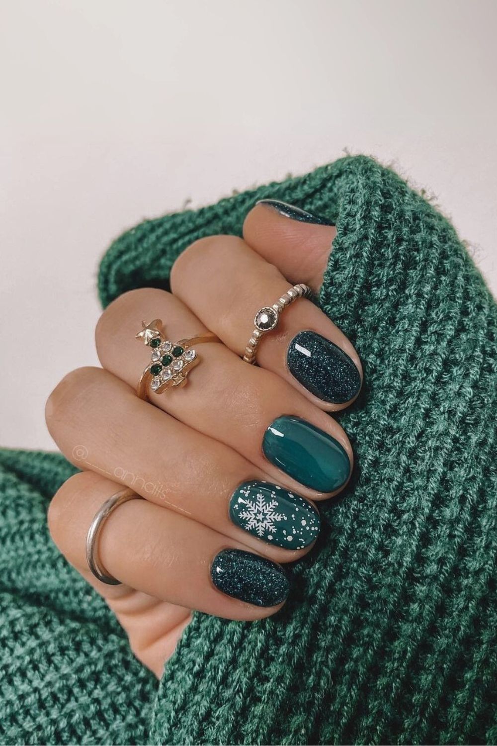 Dark green nails with snowflakes and glitter