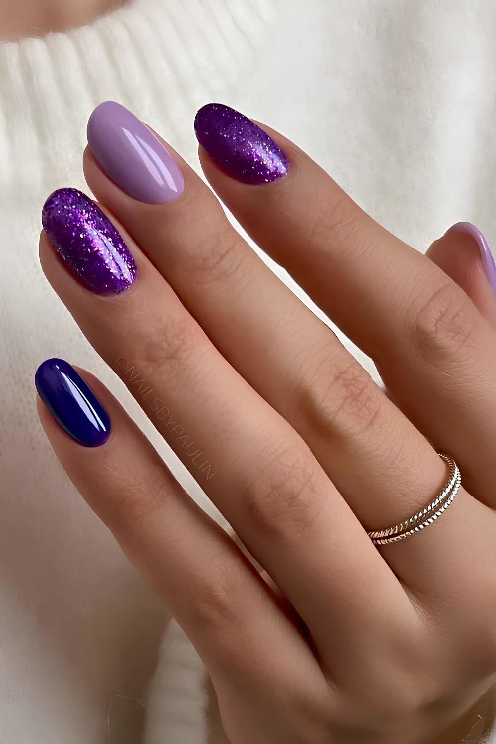 Dark purple nails with glitter accents