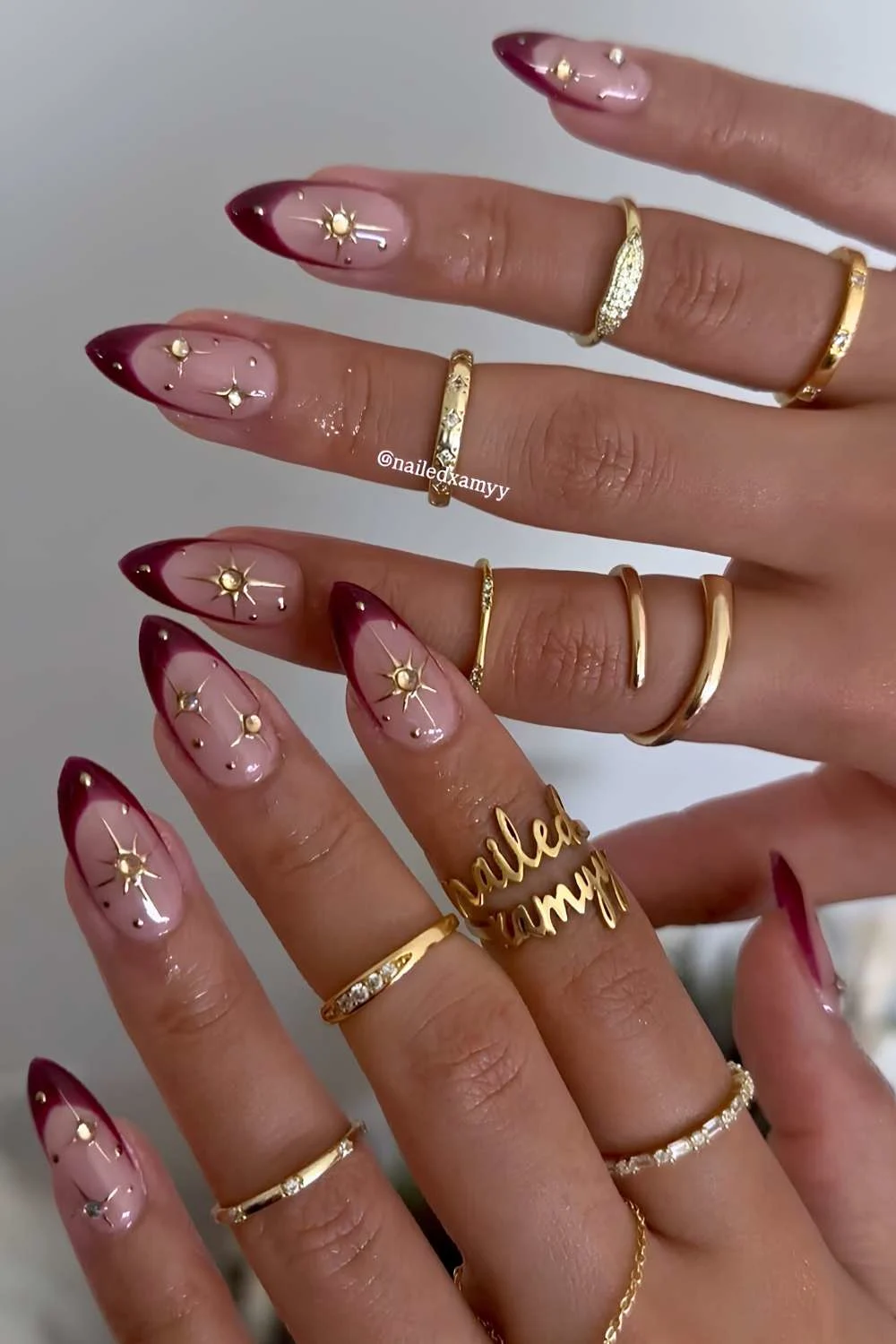 Dark red French tips with gold star art