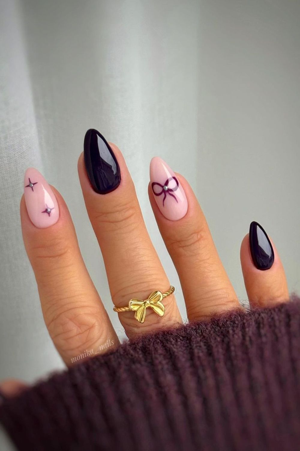 Deep purple nails with bow and star accents