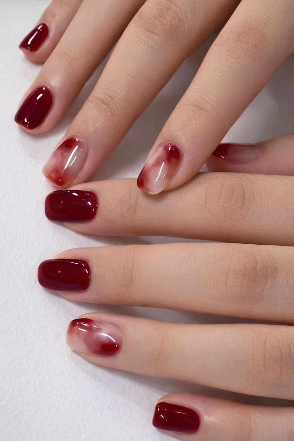 Deep red nails with accent marble art