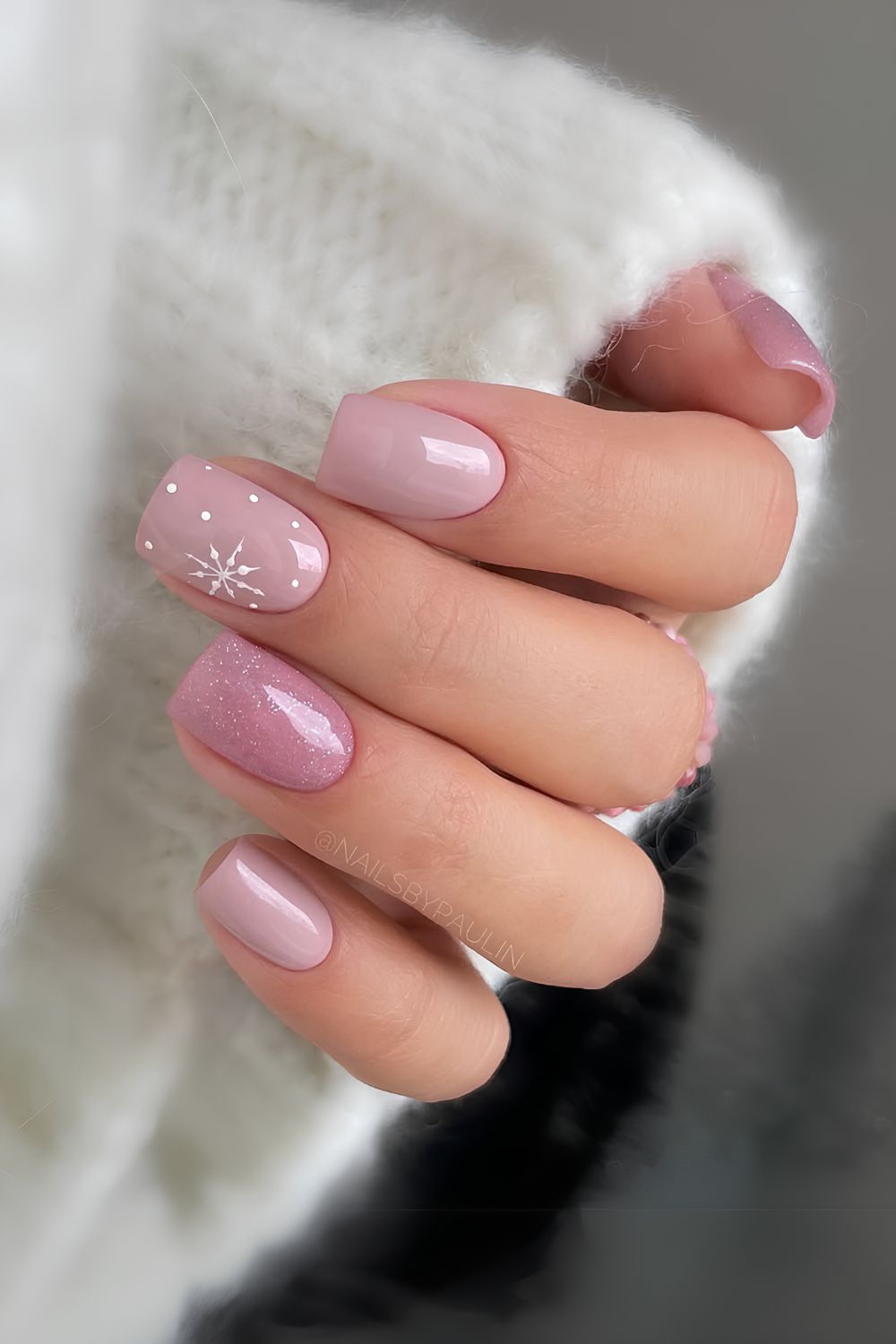 Dusty pink nails with snowflake accent