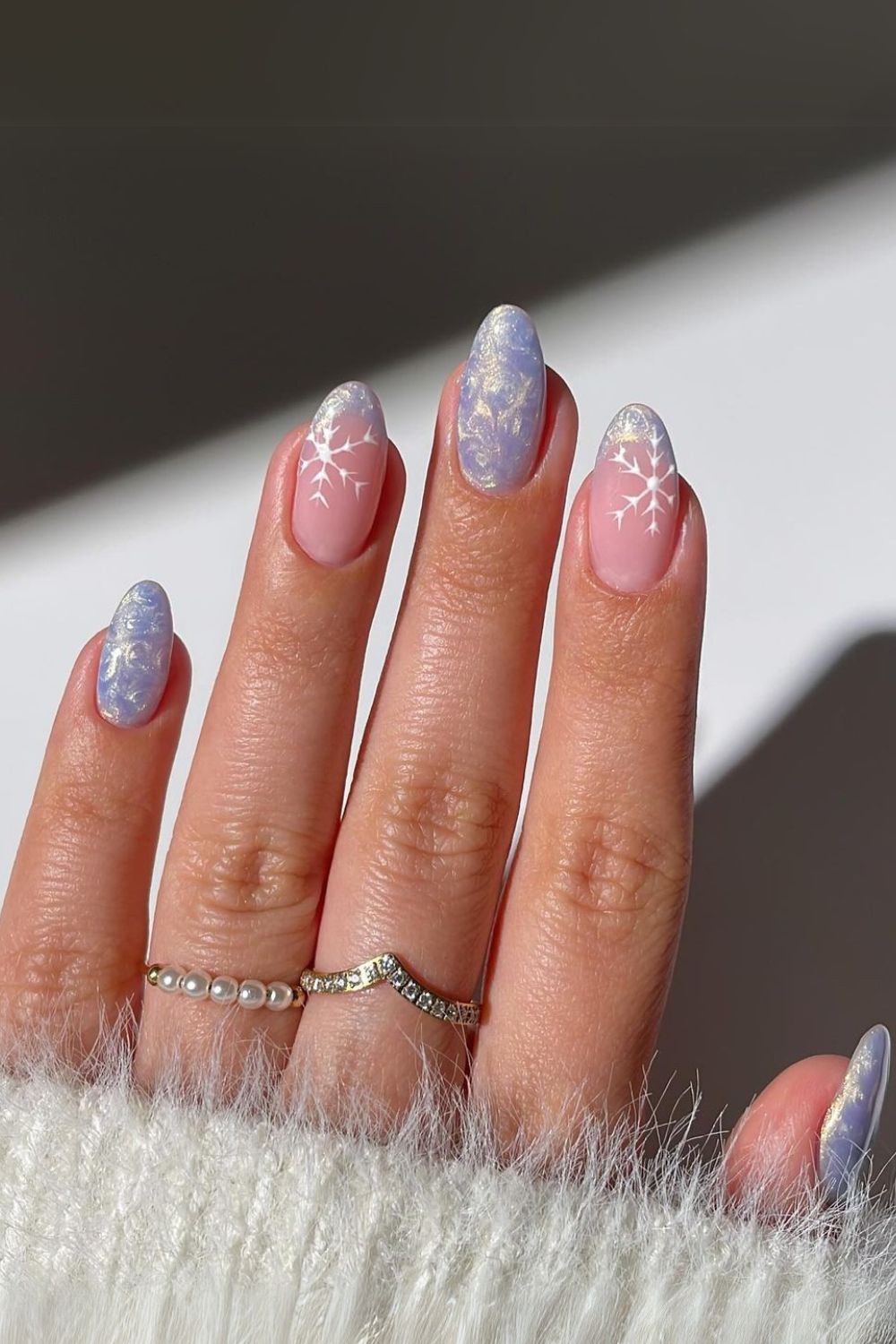 Frosty pearl nails topped with snowflakes