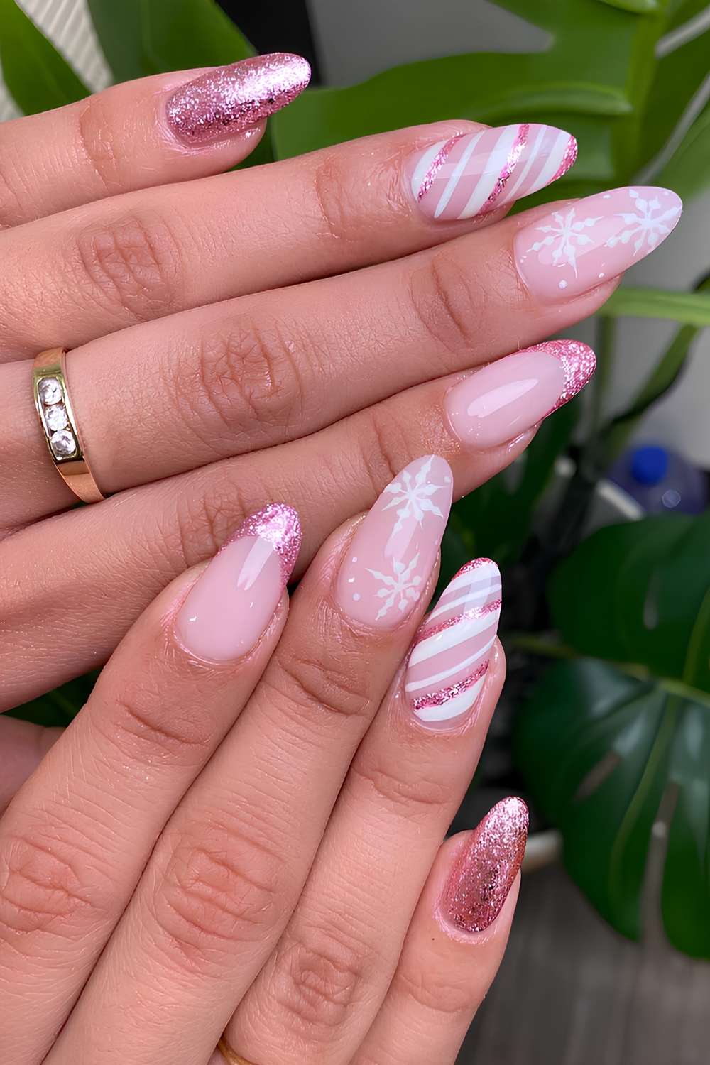 Glittery pink nails with snowflakes and candy swirl art