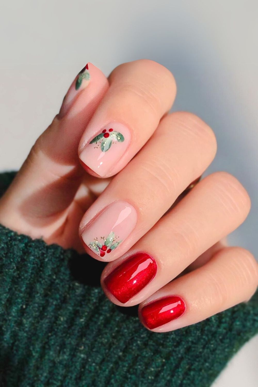 Glossy red nails and nude nails with holly accents