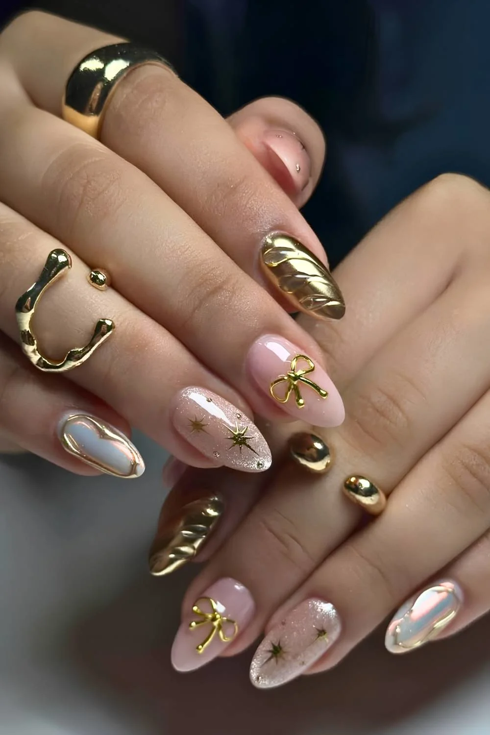 Gold nails with textured bows and swirls