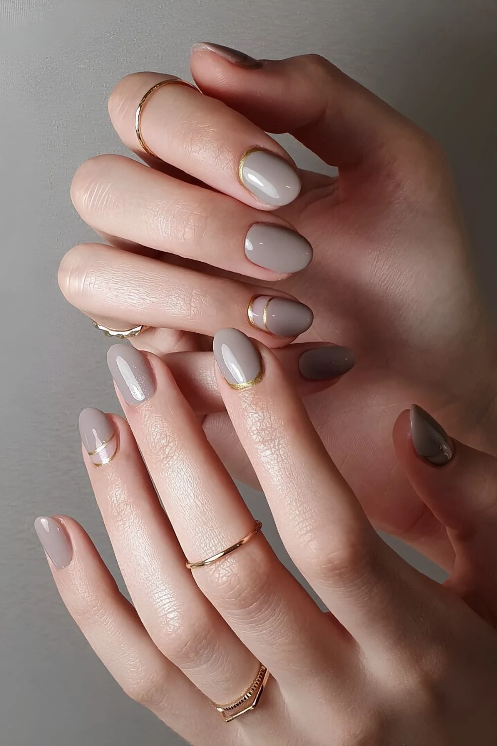 Gray nails with accent gold lines