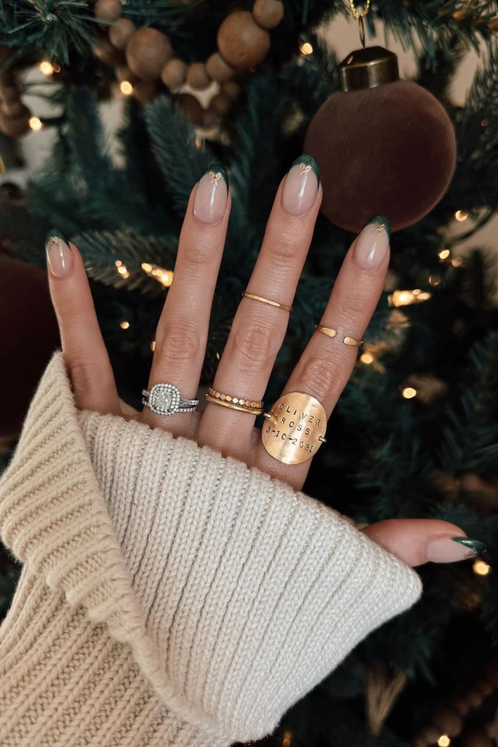 Green French tip nails with gold bow accents