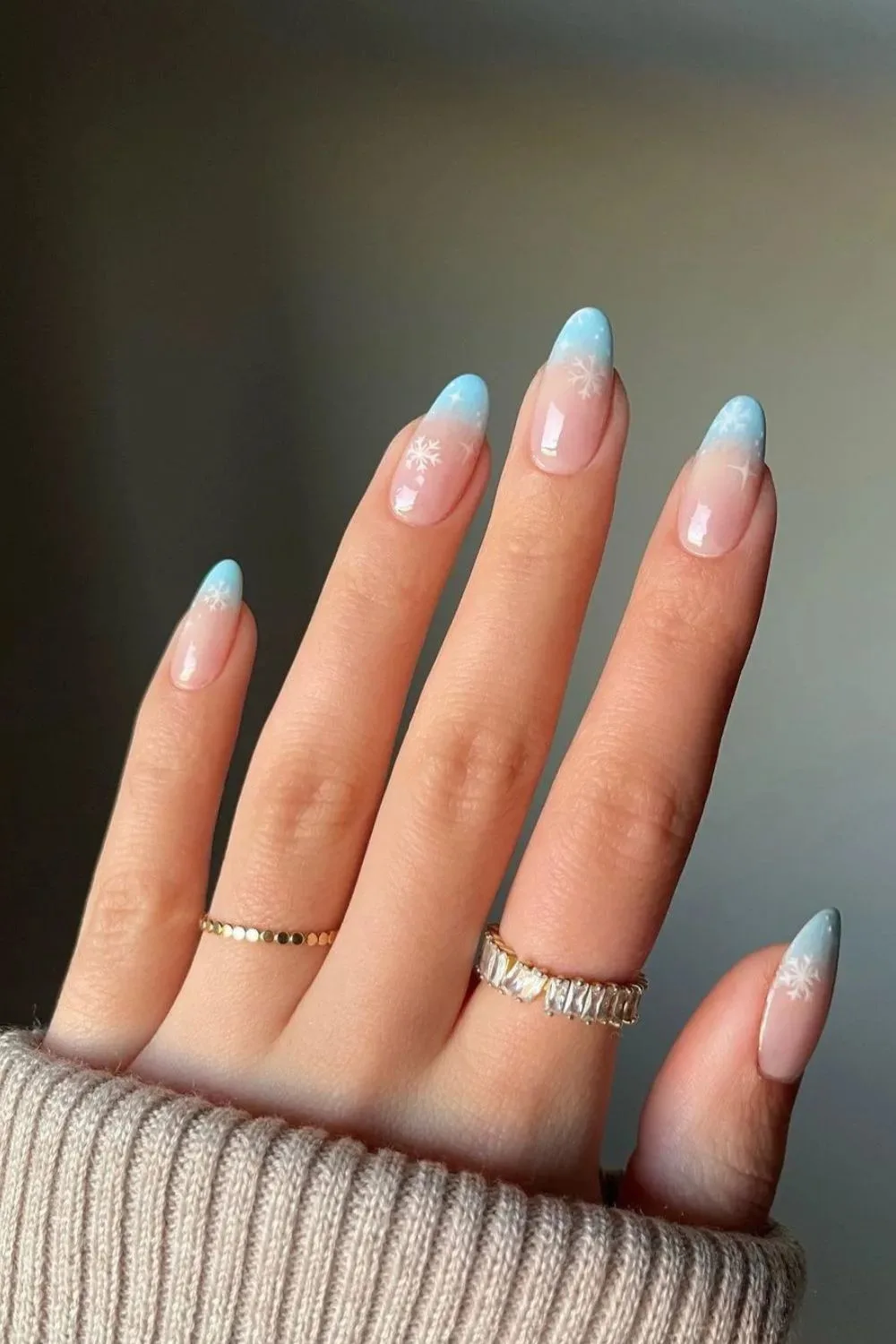 Icy blue french tip nails with snowflake accents