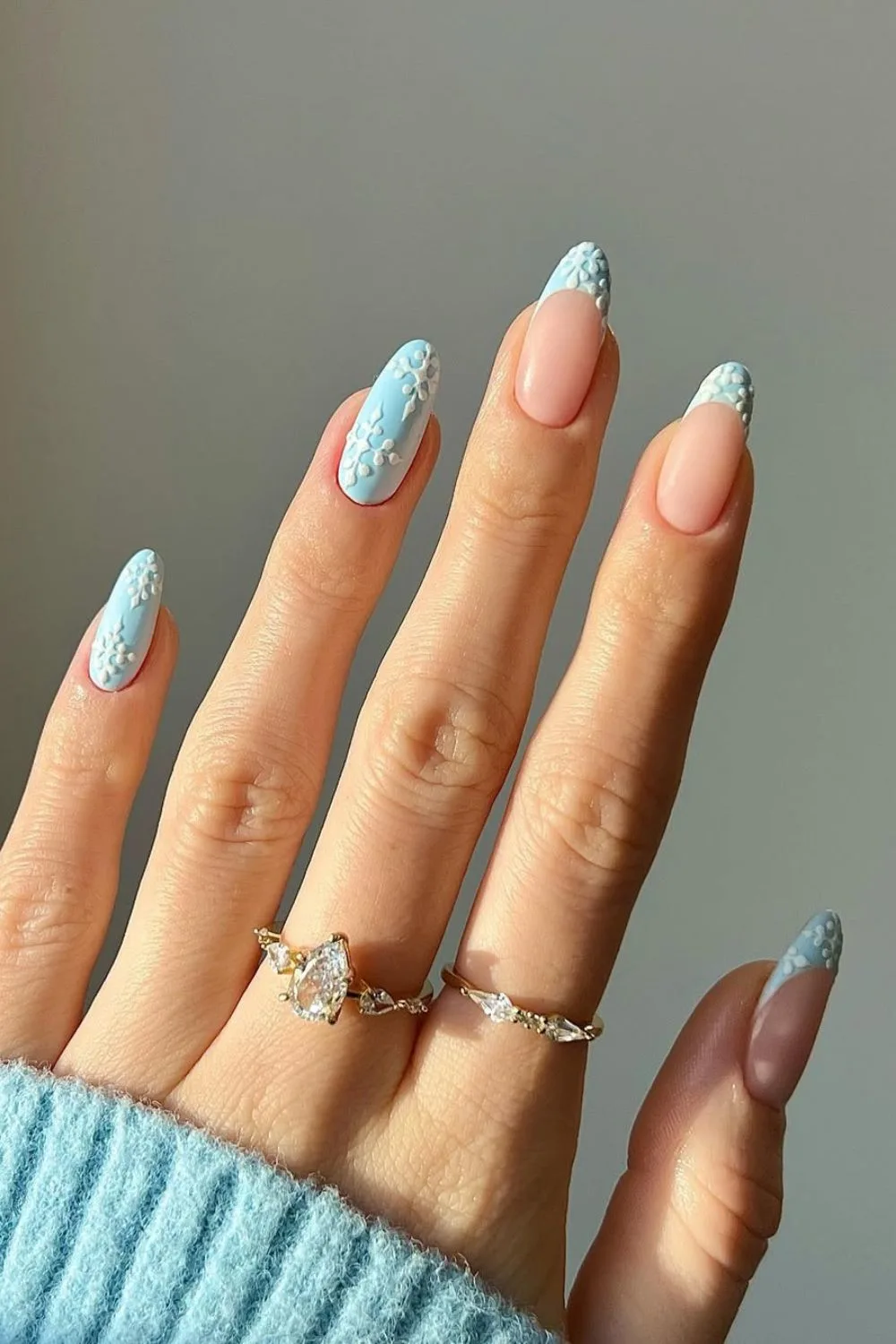 Icy blue french tip nails with snwflake accents