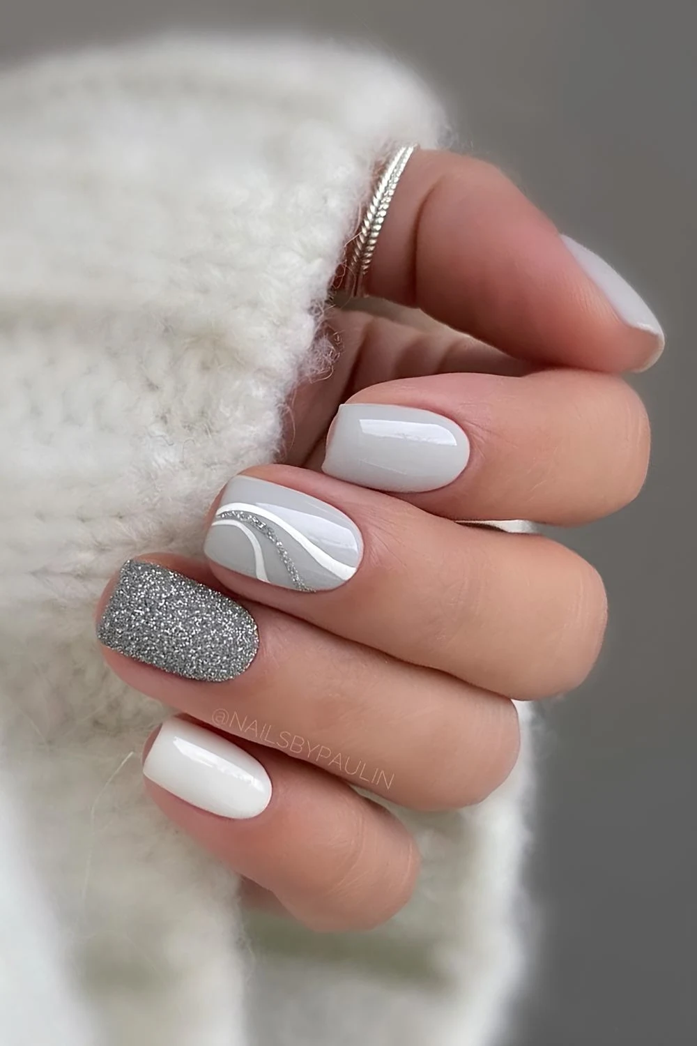 Light gray nails with glitter and swirls