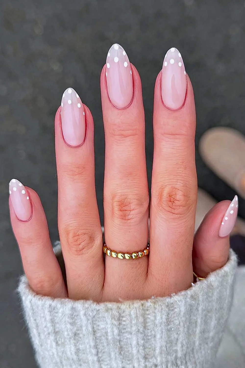 Milky white nails with polka dots at the tips