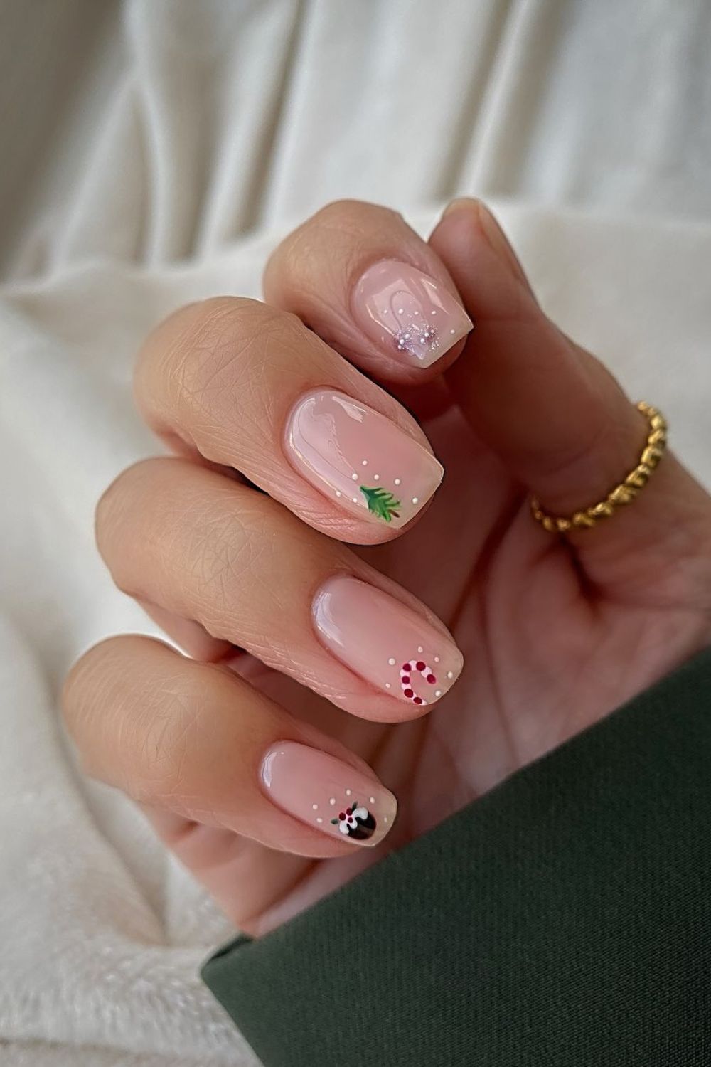 Minimalist Christmas nails nude base with tiney christmas motives