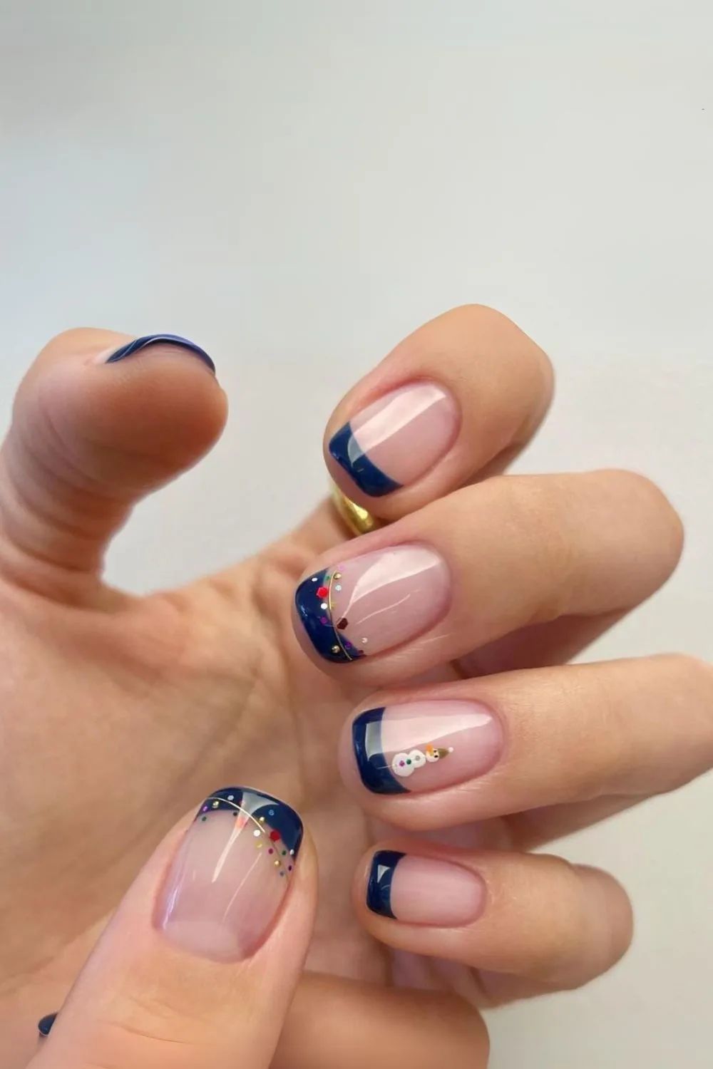 Navy French tip nails with holiday accents