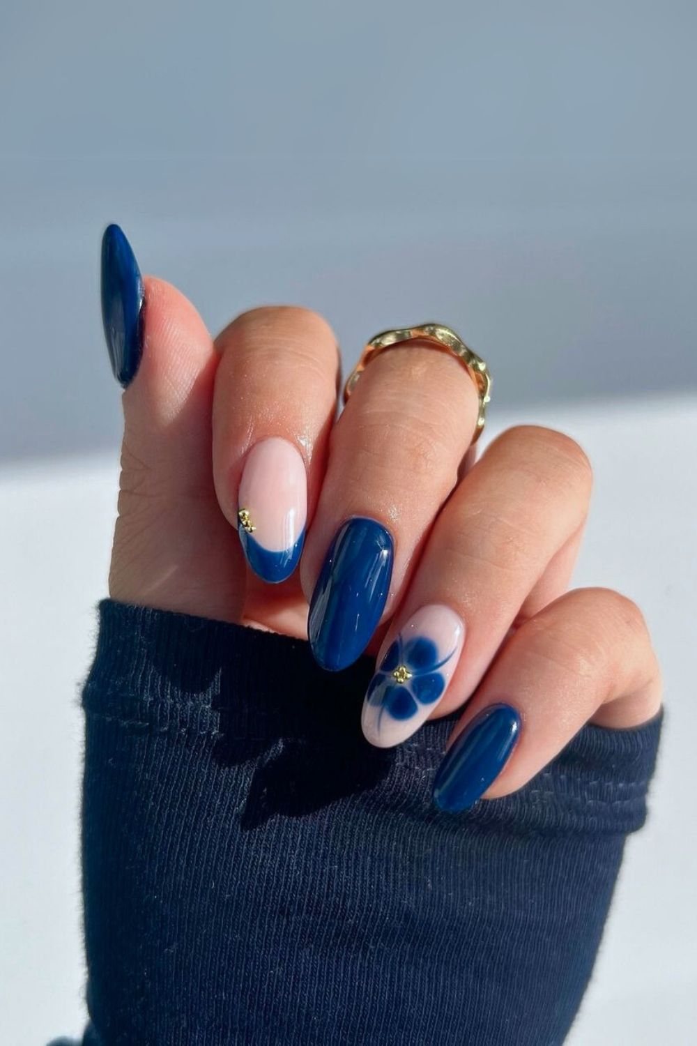 Navy nails with blooming flower accents