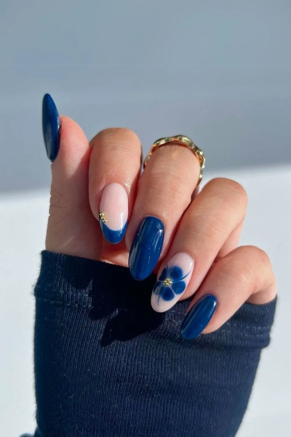 Navy nails with blooming flower accents