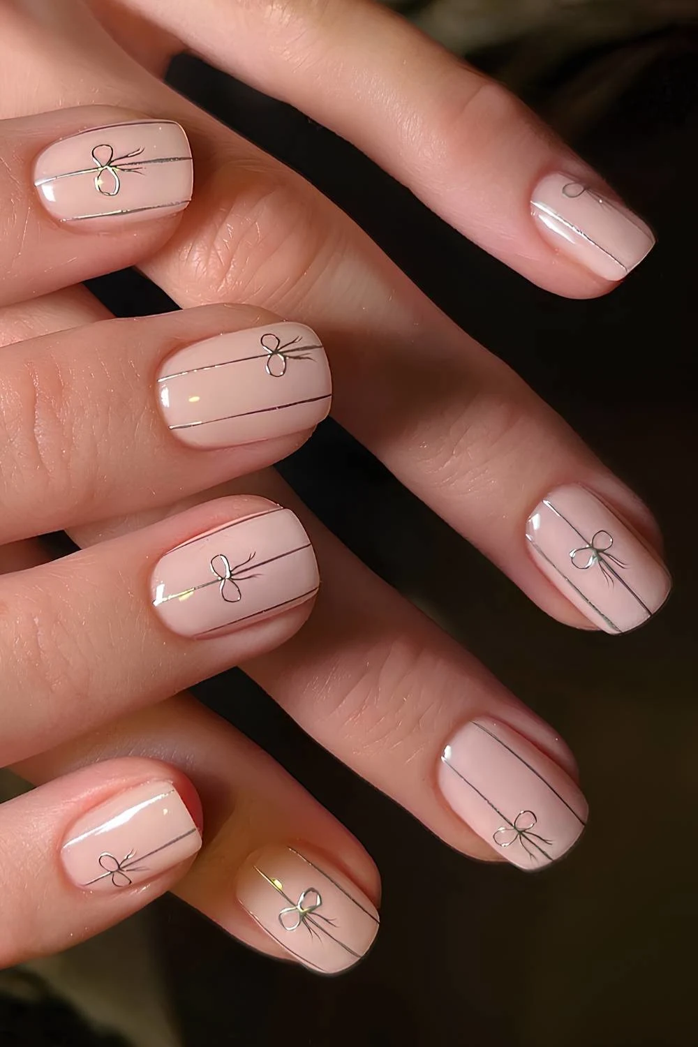 Neutral nails with chrome lines and bows