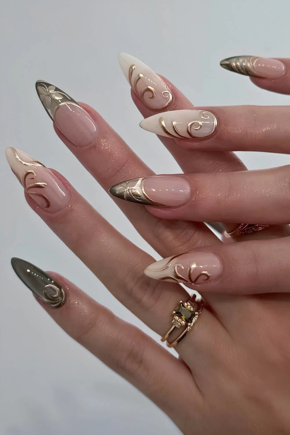 Neutral nails with gold chrome detailing