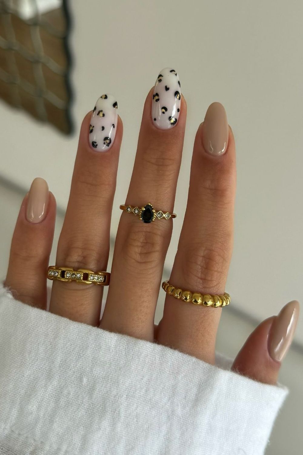 Neutral nails with leopard print accents