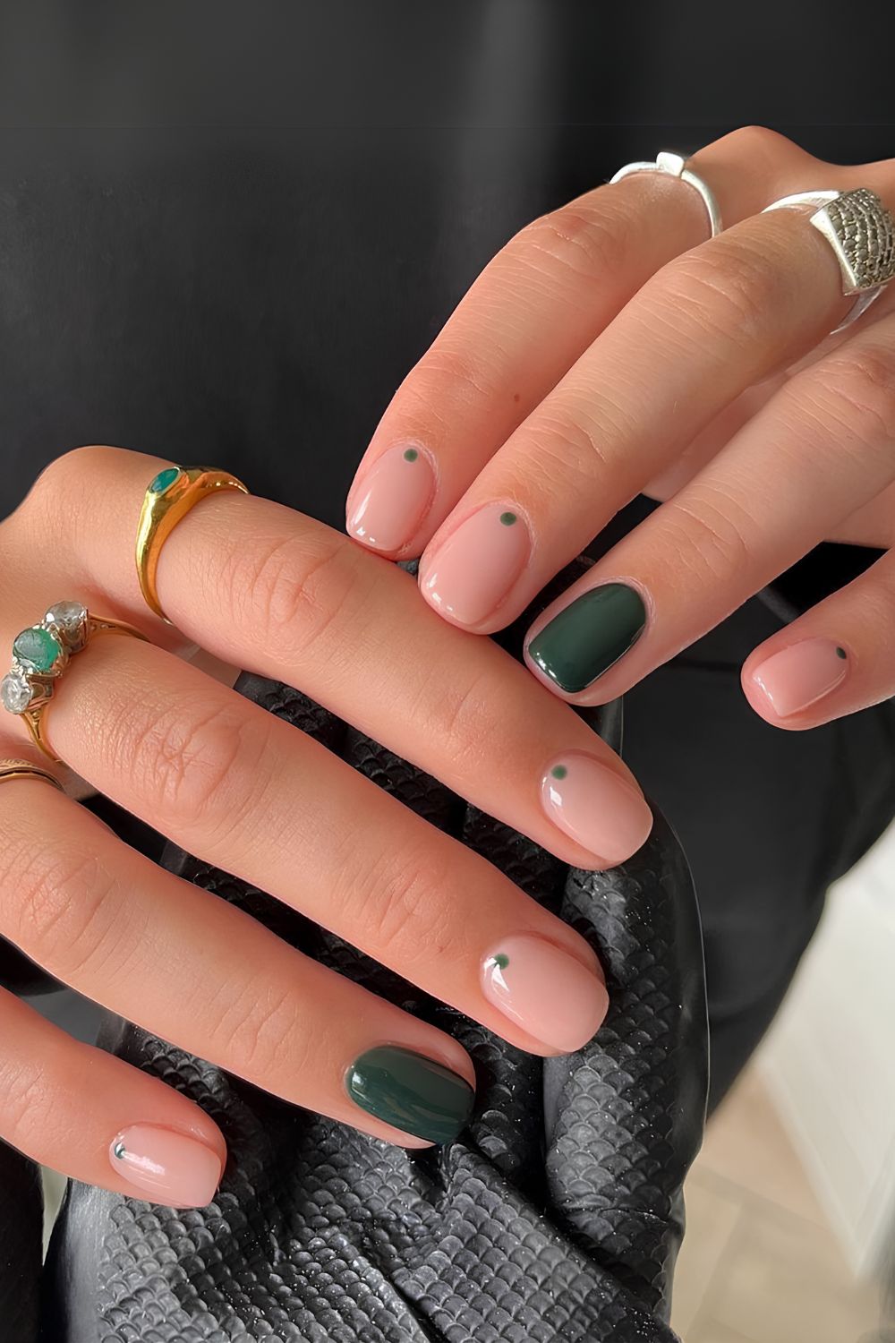 Nude and dark green nails with dot accents