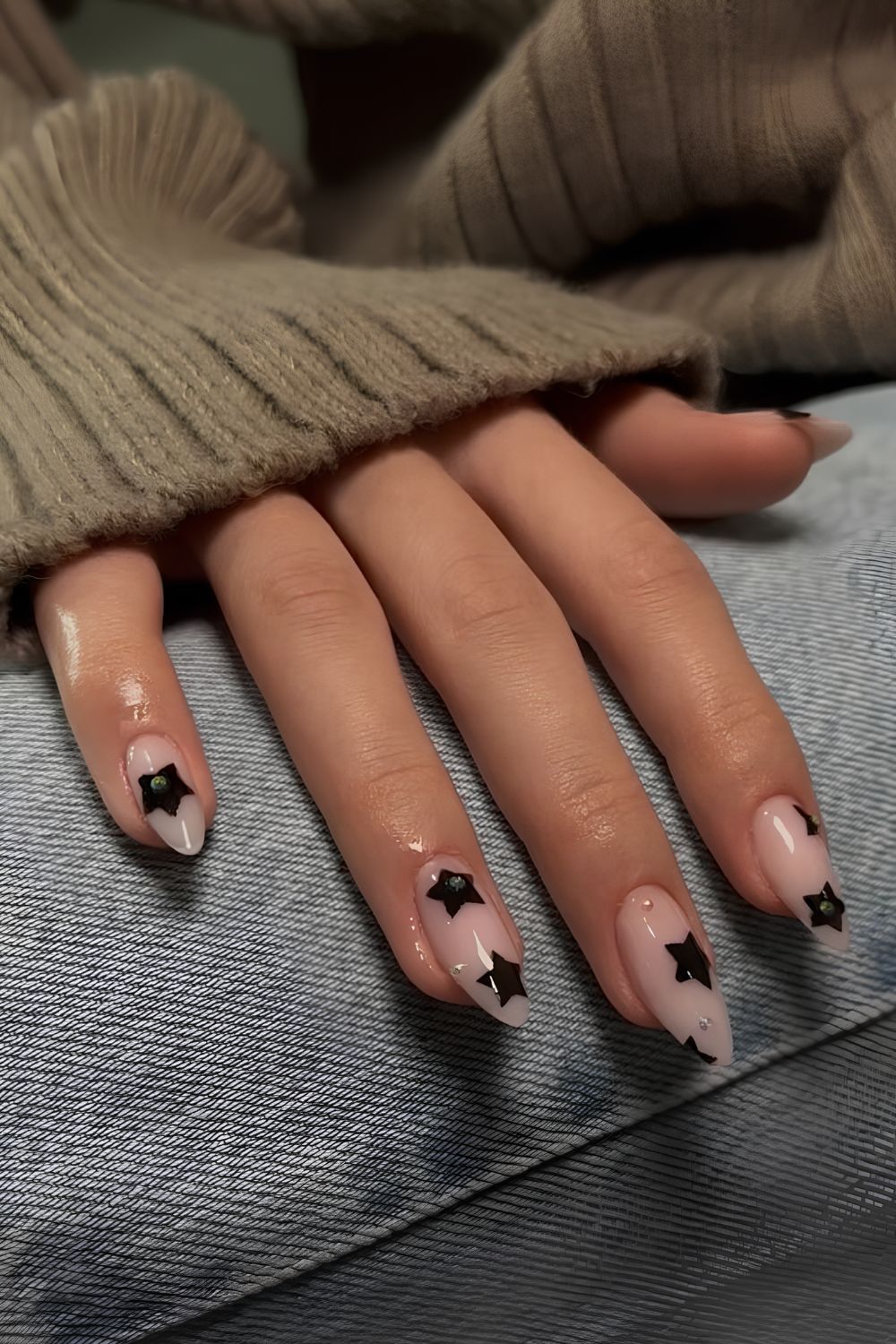 Nude nails with black star accents