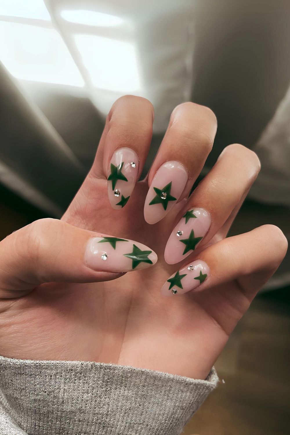 Nude nails with green stars and rhinestones