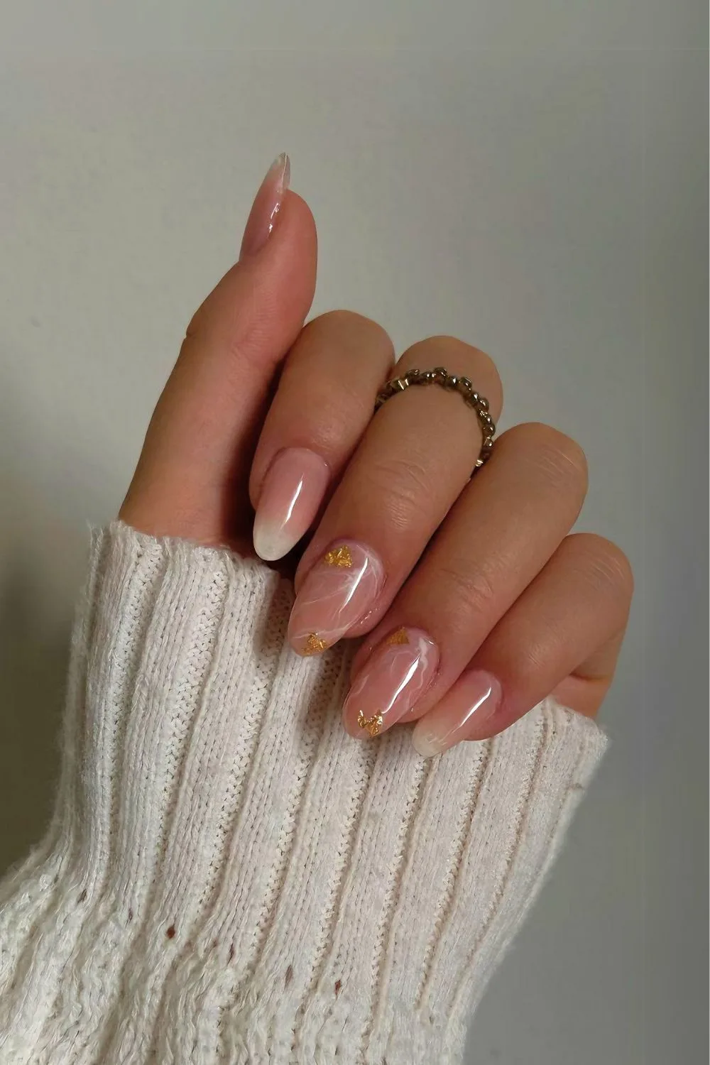 Nude nails with marble and gold foil accents