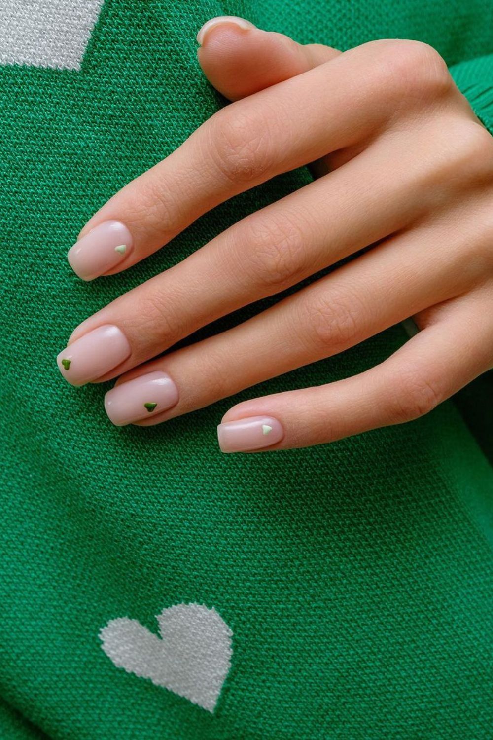 Nude nails with white and green hearts