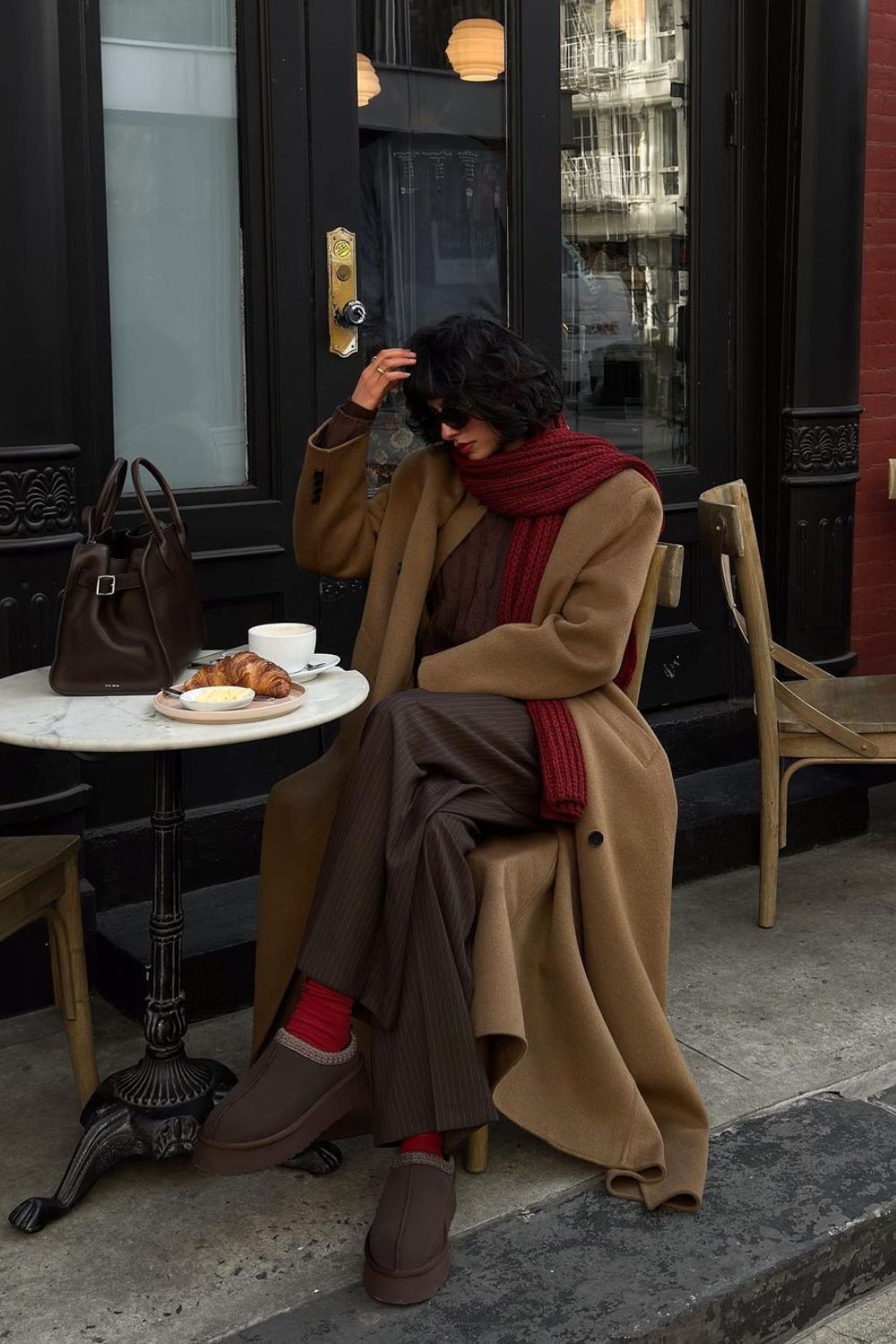 Oversize camel coat with brown wide-leg pants paired with red scarf and socks