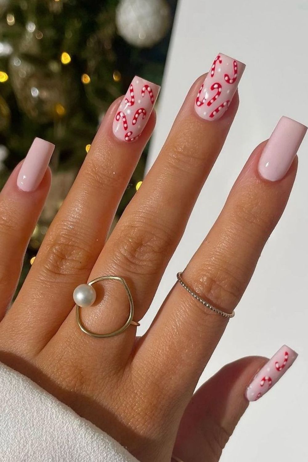 Pastel pink nails with candy cane details