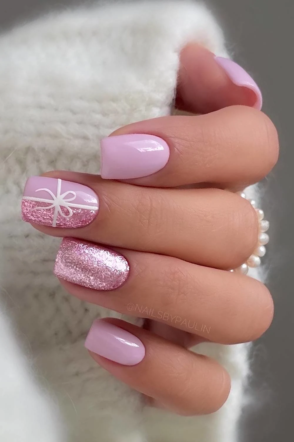 Pink Christmas nails with bows and glitter