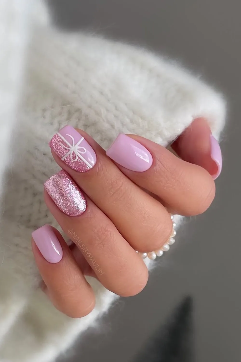 Pink Christmas nails with gift bow art