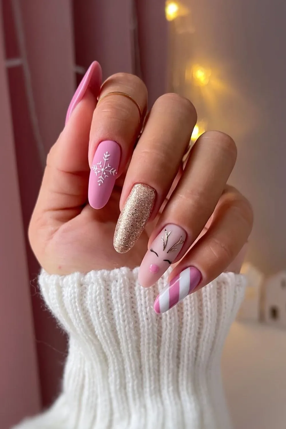 Pink and gold Christmas nails with reindeer design