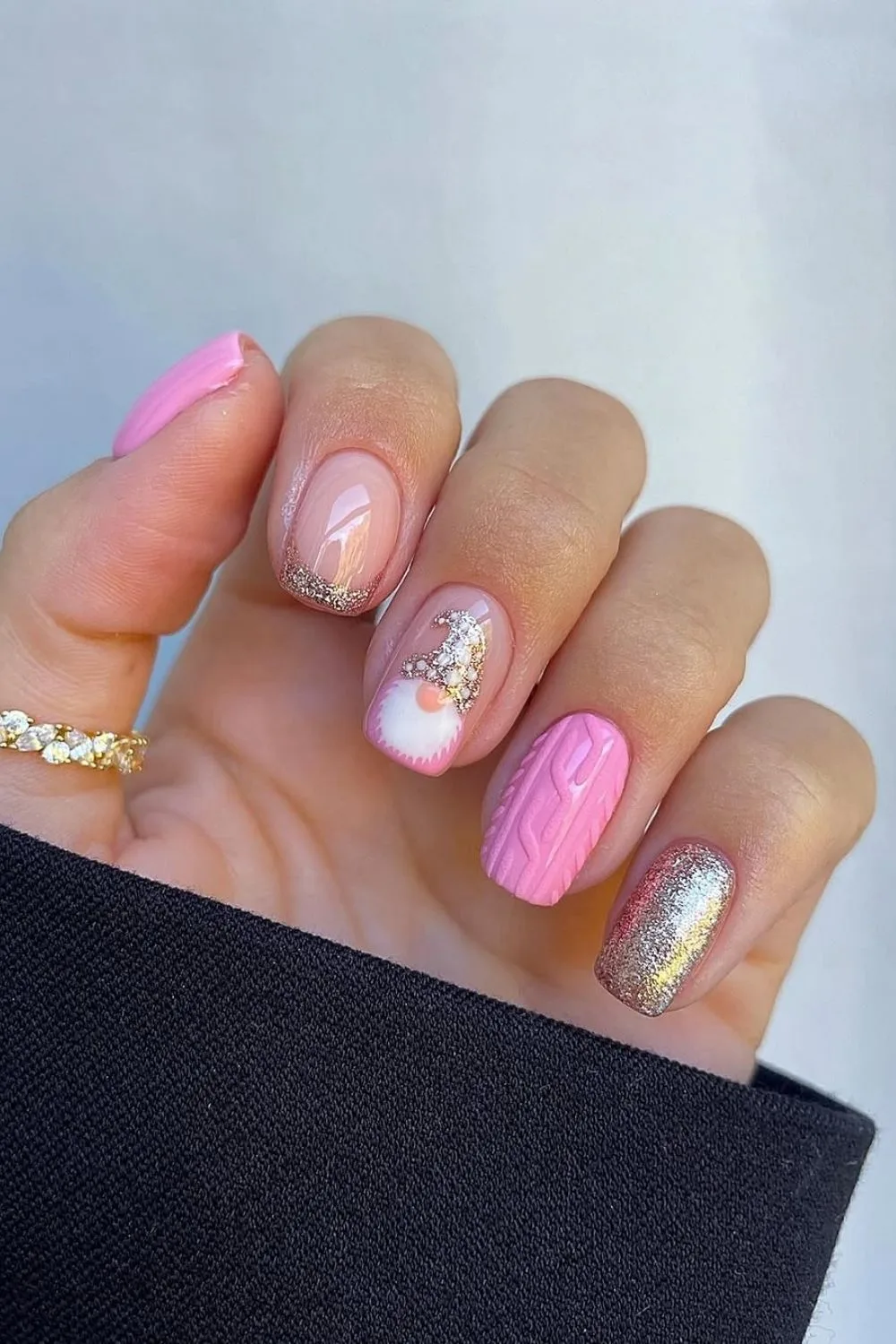 Pink and gold nails with Christmas Gonk accent