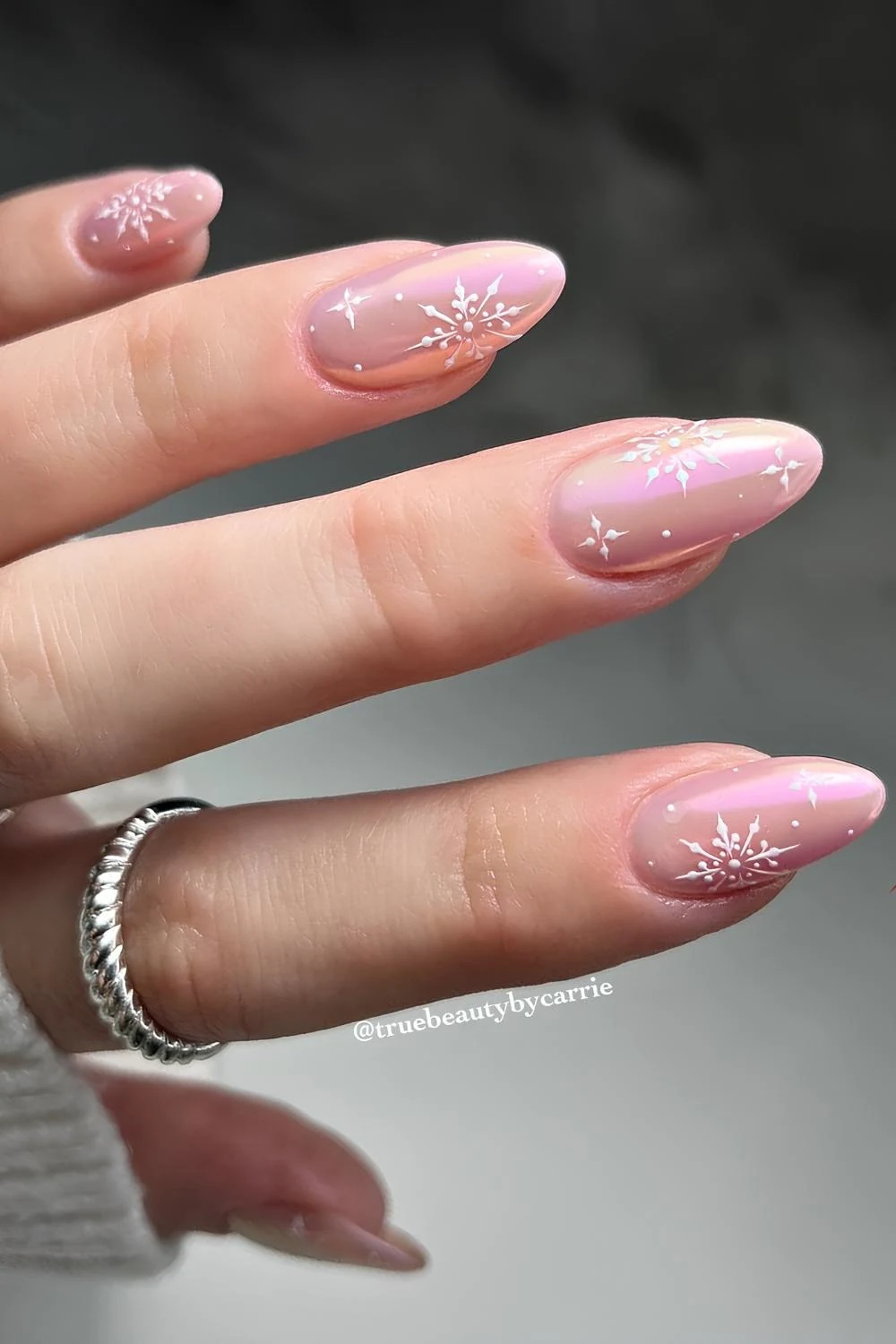 Pink chrome nails with snowflake art