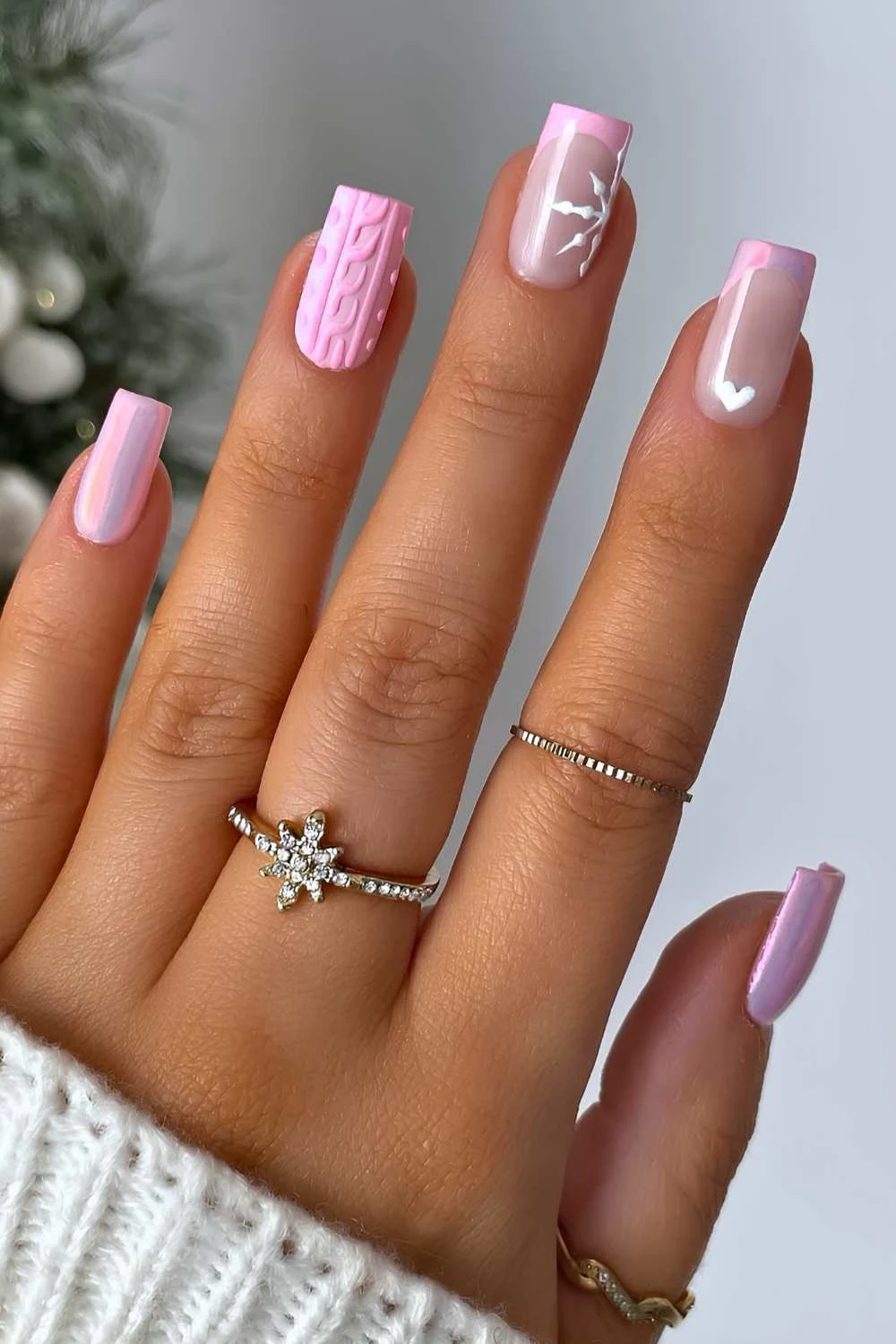 Pink mani with sweater art and snowflakes