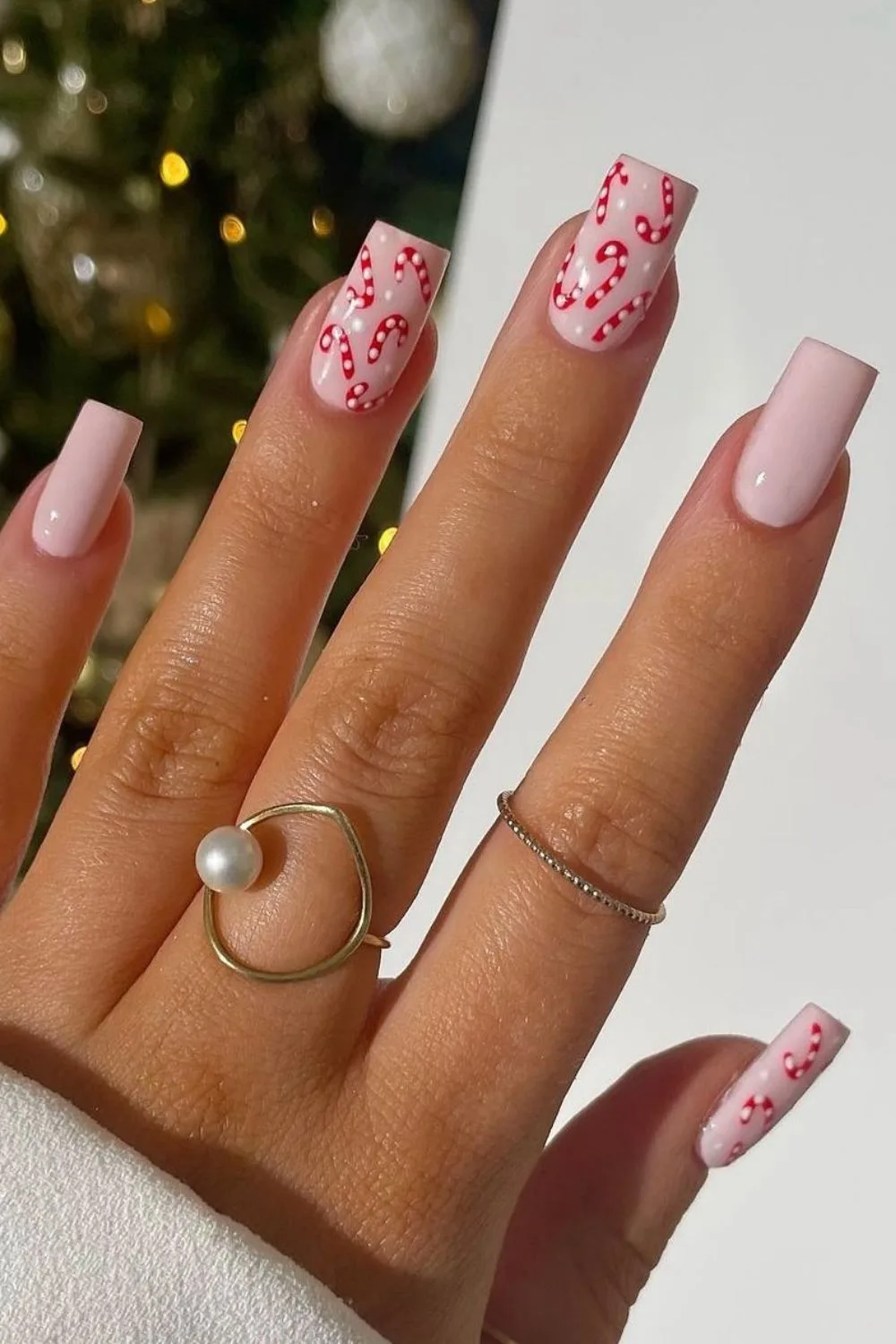 Pink nails with candy cane accents