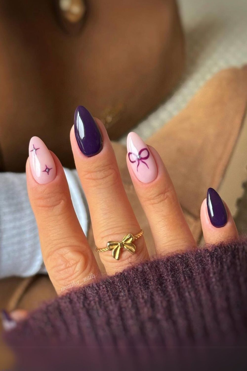 Purple nails with accent bows and stars