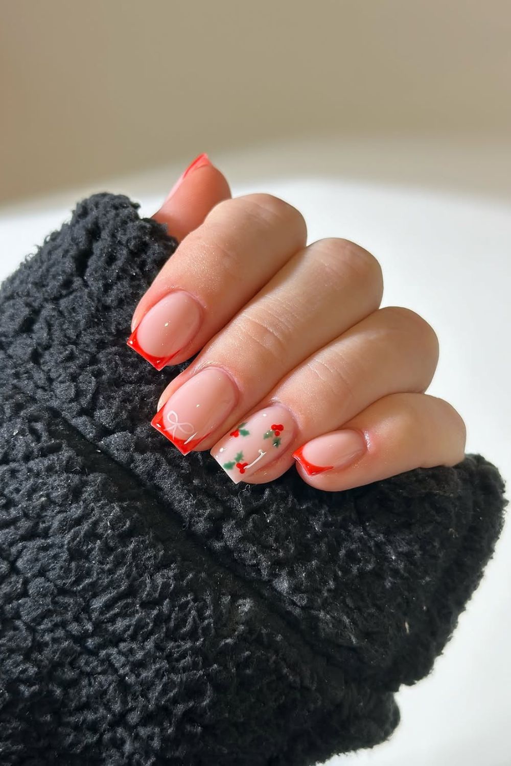 Red French tip nails with holly berry accent