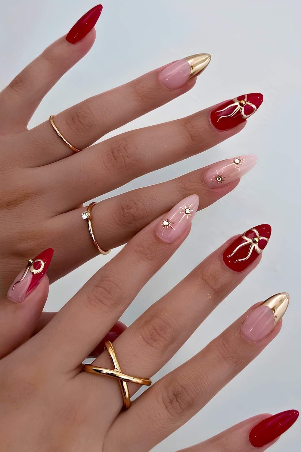 Red and gold nails with rhinestones and bows