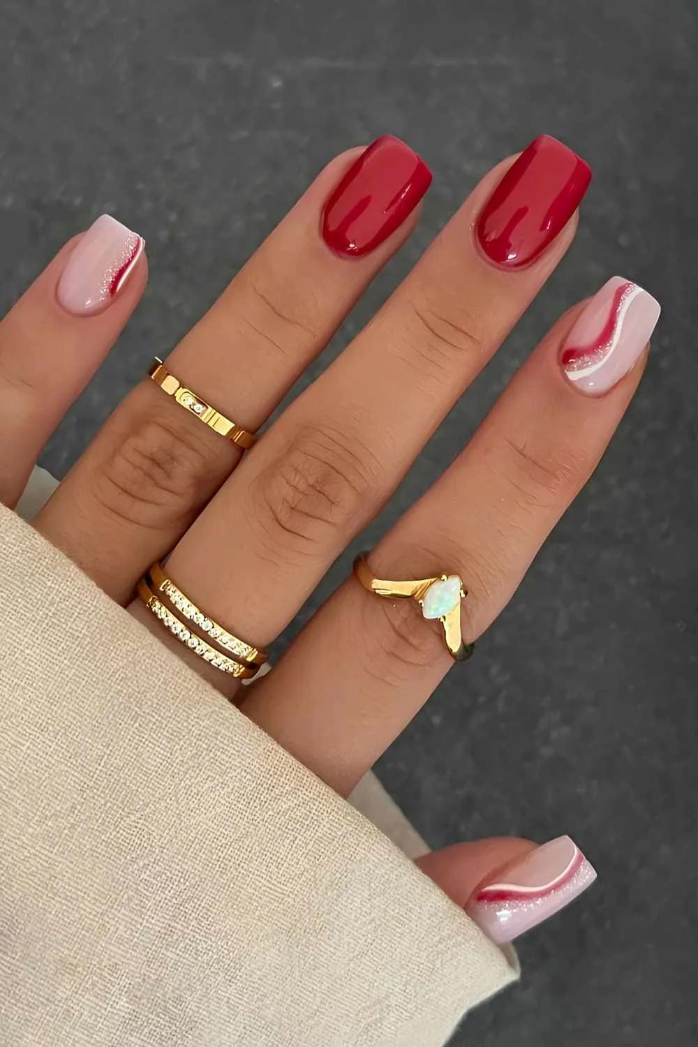 Red and white nails with accent swirls