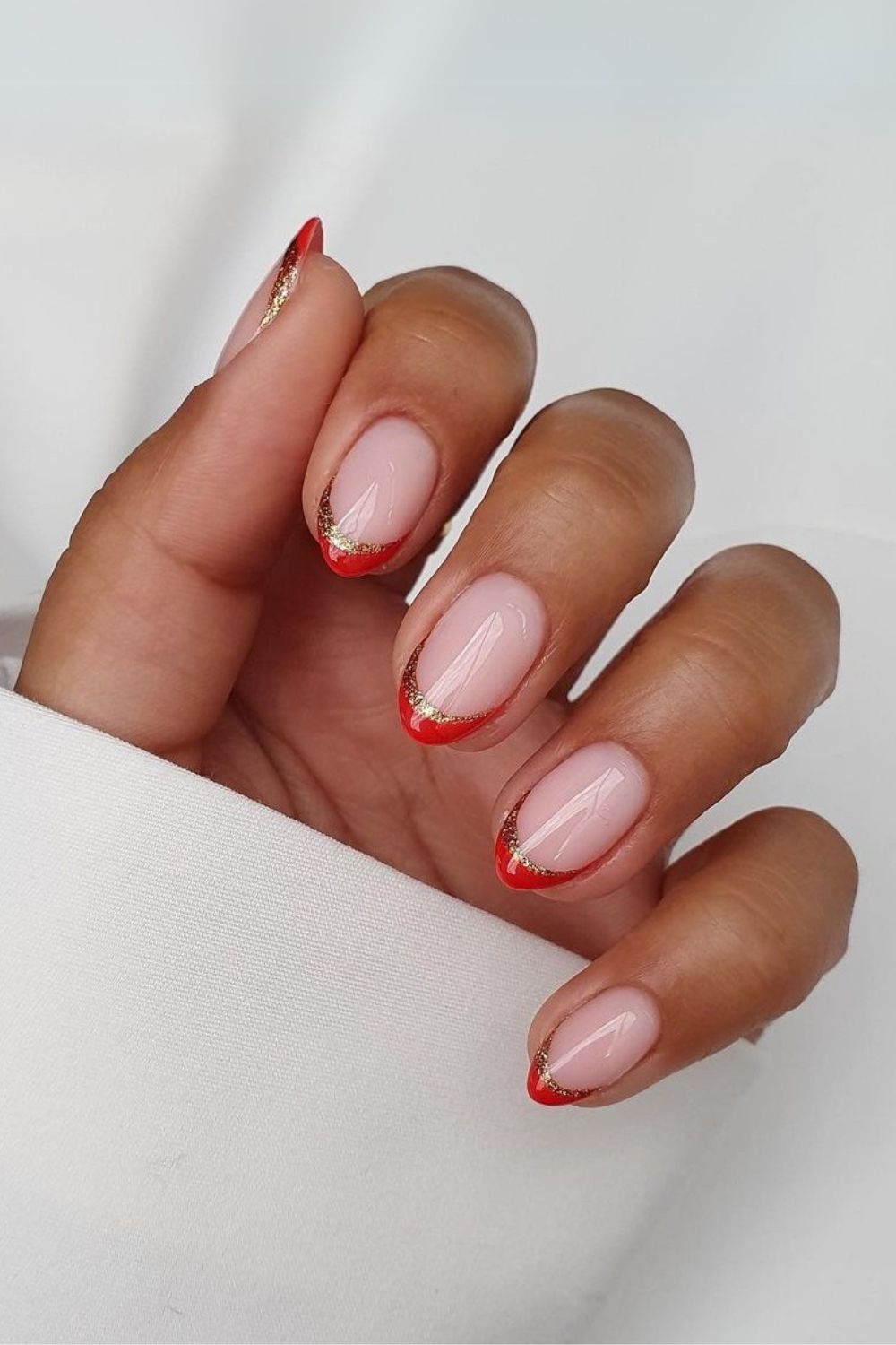 Red glitter-edged French tip nails