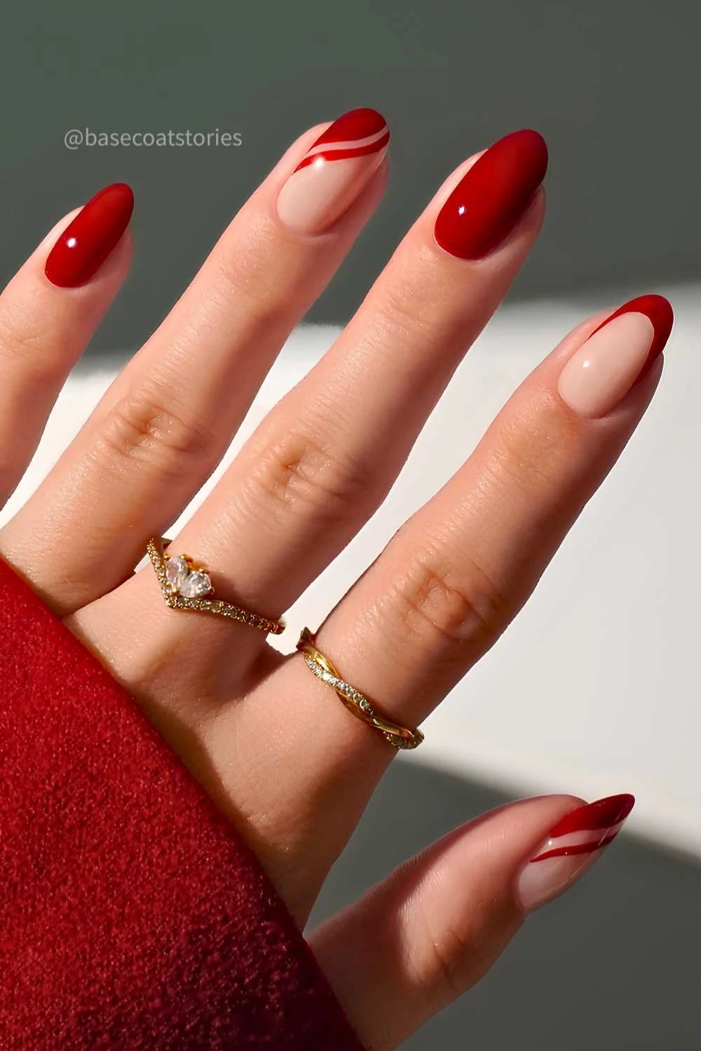 Red nails with accent swirls and French tips