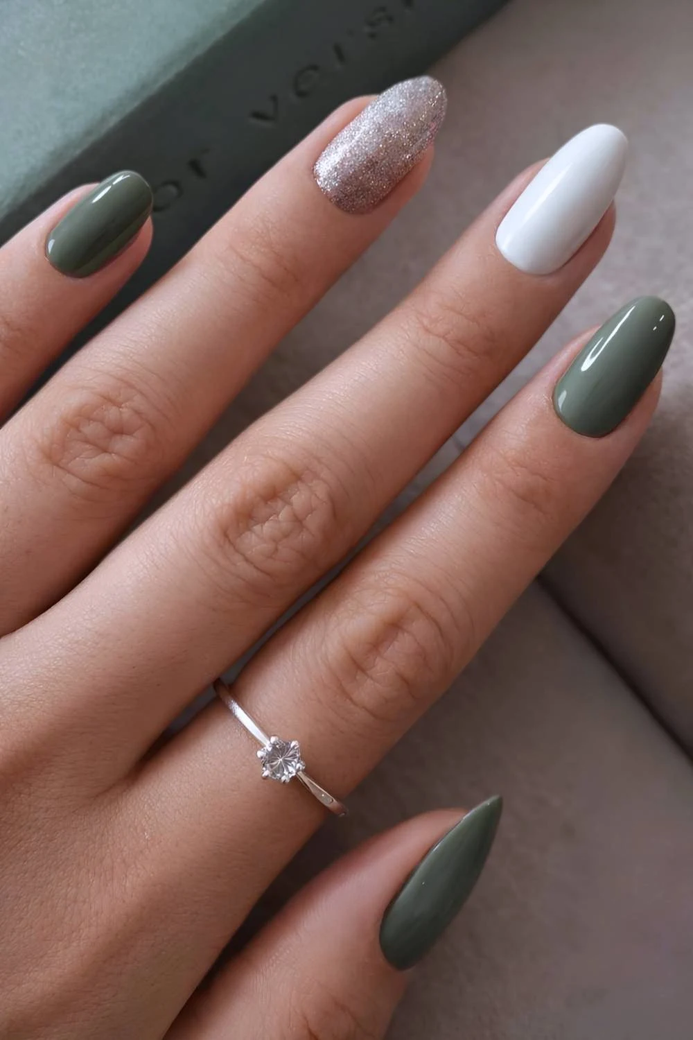 Sage green and white nails with glitter