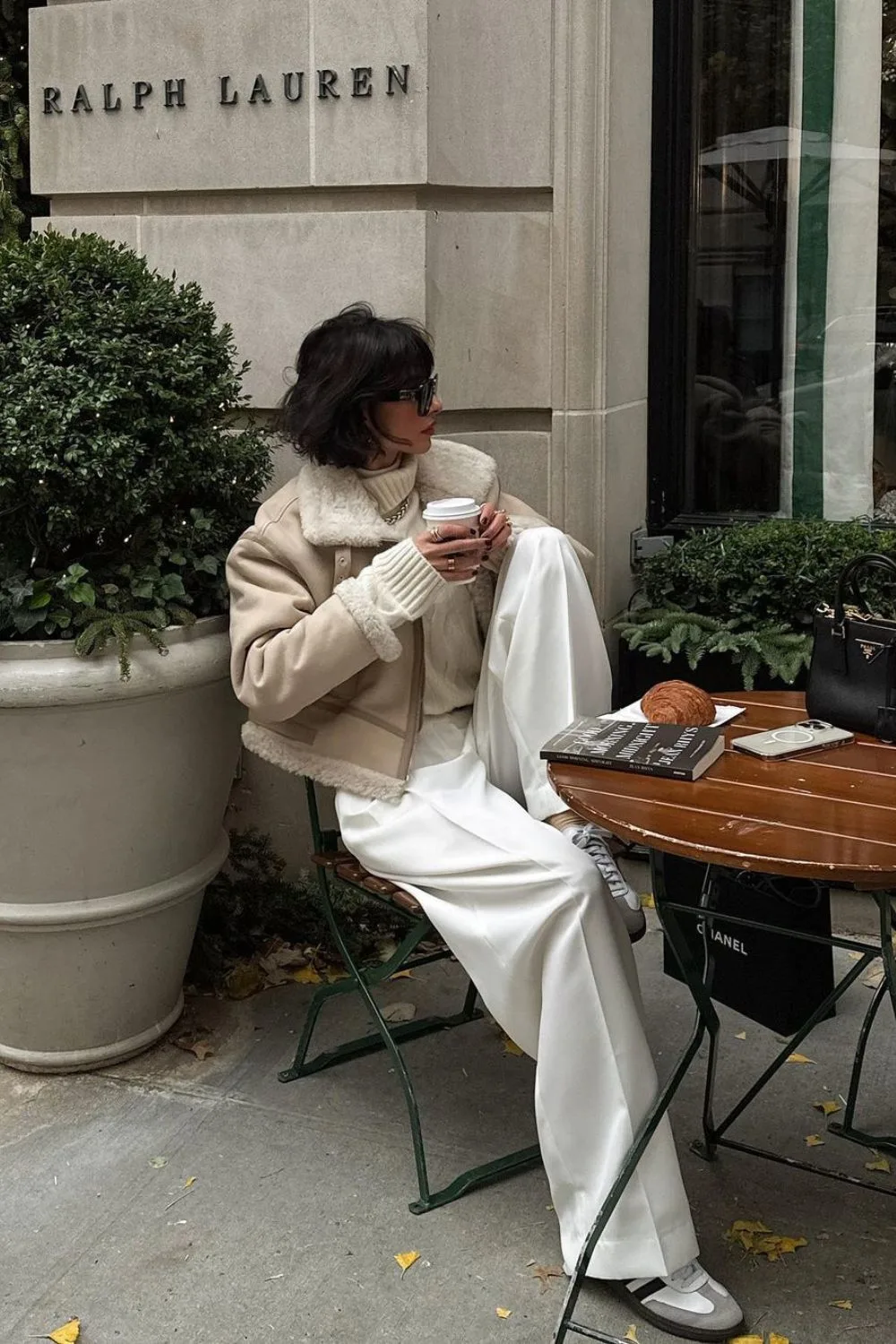 Shearling Jacket & White Trousers paired with beige sweater