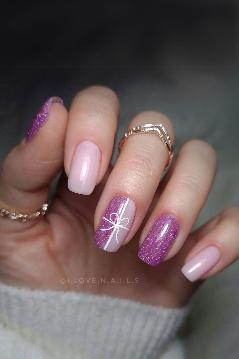 Shimmery purple nails with gift bow art