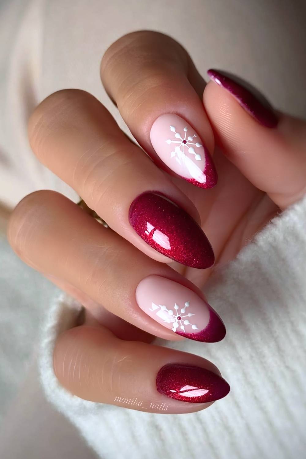 Shimmery red holiday nails with snowflakes