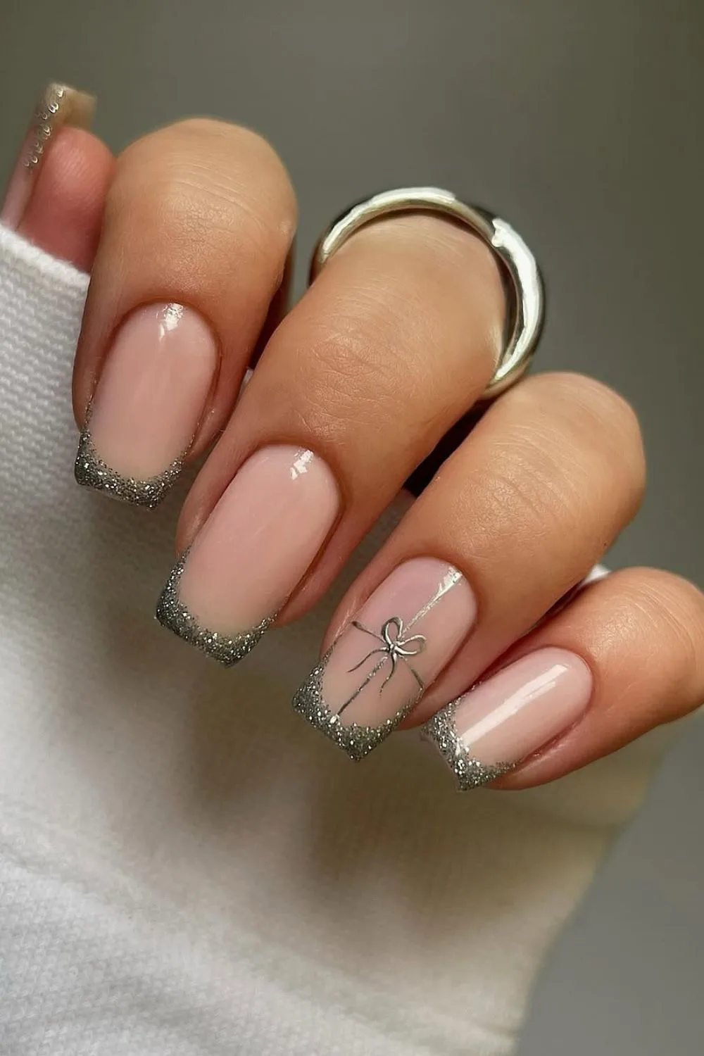 Shimmery silver french tips with gift accent